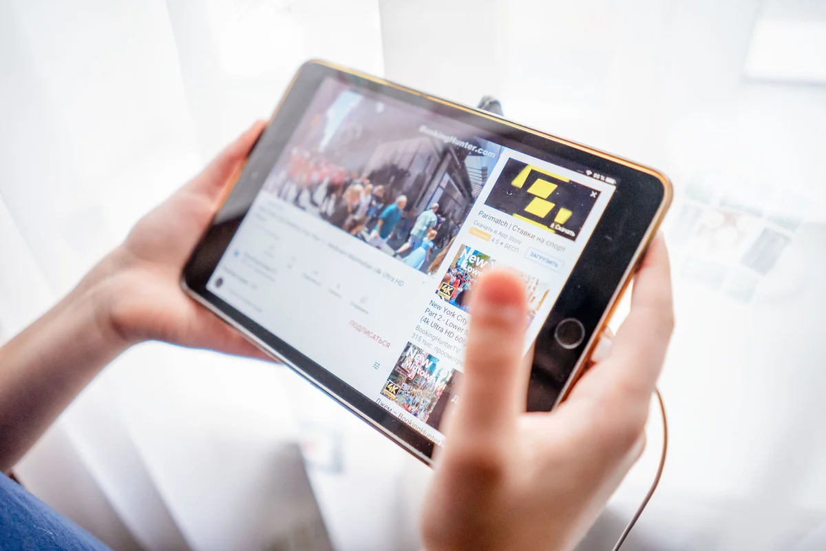 iPad-Bildschirm mit geöffneter Video-App in hell beleuchteter Wohnumgebung