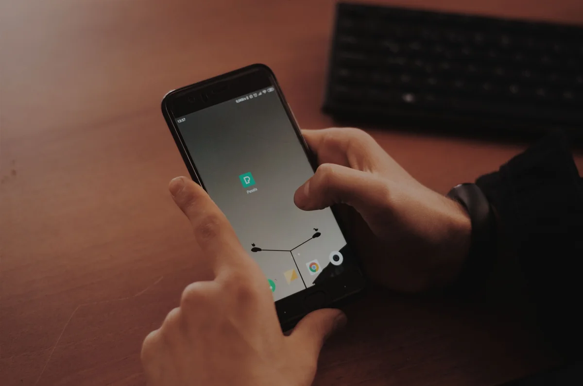 Hand tapping a phone screen during an app installation
